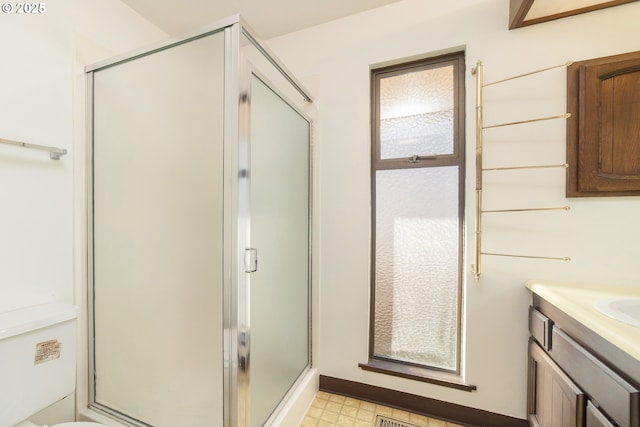 bathroom with vanity and a shower with shower door