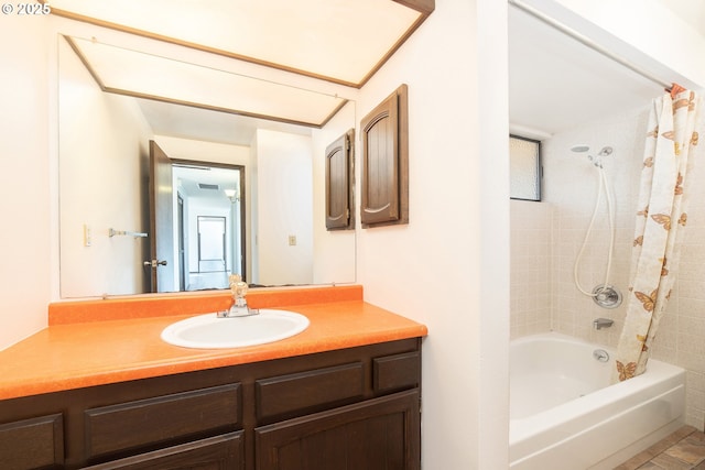 bathroom with vanity and tiled shower / bath combo