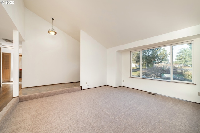 unfurnished room featuring carpet and high vaulted ceiling