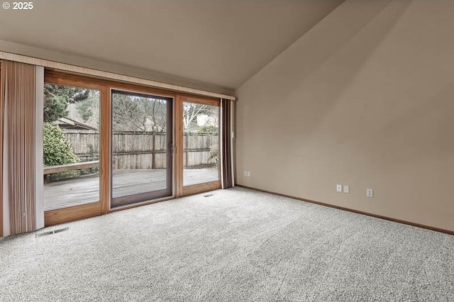 spare room with vaulted ceiling and carpet