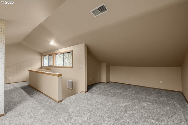 bonus room featuring lofted ceiling and light colored carpet