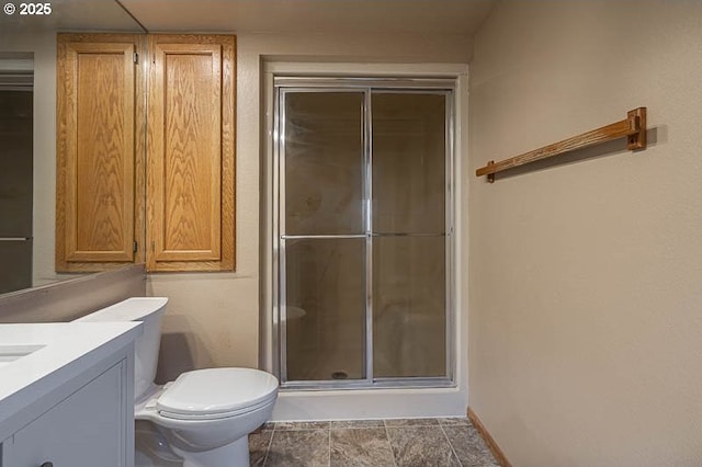 bathroom with a shower with door, toilet, and vanity