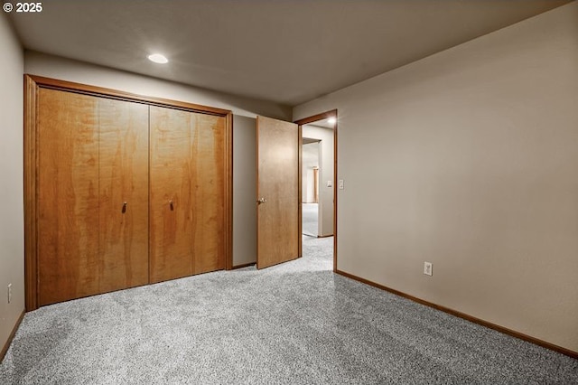 unfurnished bedroom featuring a closet and carpet flooring