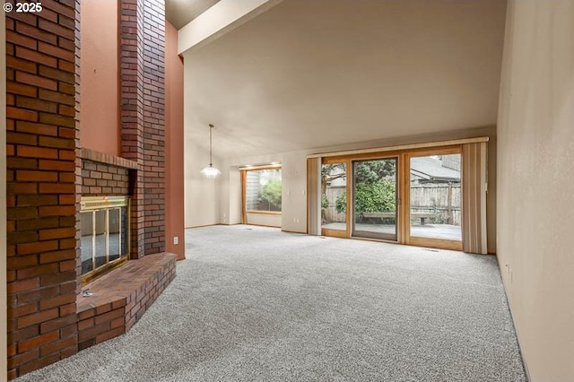 unfurnished living room with a brick fireplace, carpet floors, and high vaulted ceiling