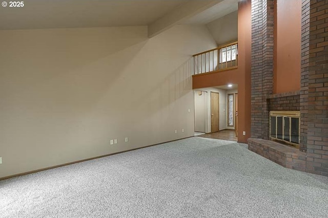 unfurnished living room featuring a brick fireplace, light carpet, and vaulted ceiling with beams