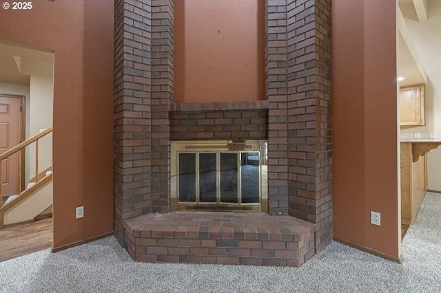 room details featuring a fireplace and carpet flooring