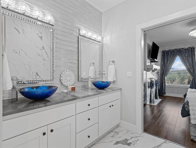 bathroom featuring vanity and backsplash