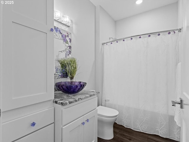 bathroom featuring vanity, hardwood / wood-style floors, curtained shower, and toilet