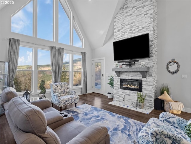 living room featuring dark wood-type flooring, a fireplace, and high vaulted ceiling