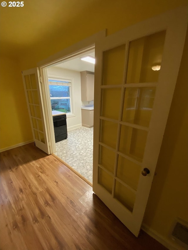 564566 Alameda Ave, Astoria, OR 97103 - hall featuring wood finished floors, french doors, and baseboards
