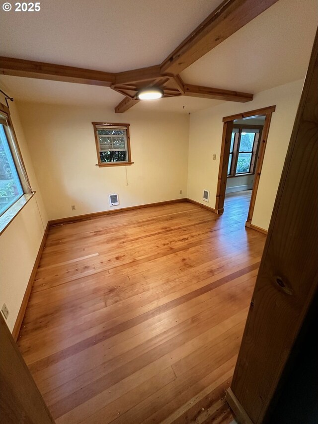 564566 Alameda Ave, Astoria, OR 97103 - spare room featuring light wood finished floors, beamed ceiling, and baseboards