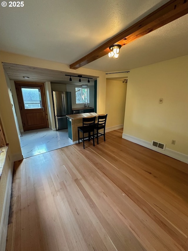 564566 Alameda Ave, Astoria, OR 97103 - dining space featuring beam ceiling, light wood-type flooring, and baseboards