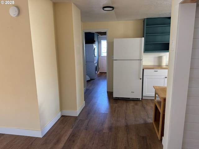 564566 Alameda Ave, Astoria, OR 97103 - hall with dark wood-style floors, baseboards, and stacked washing machine and dryer