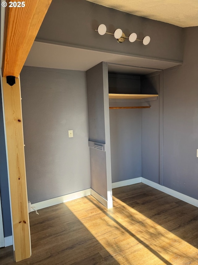564566 Alameda Ave, Astoria, OR 97103 - unfurnished bedroom featuring wood finished floors, baseboards, and a closet