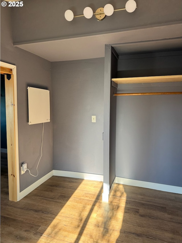 564566 Alameda Ave, Astoria, OR 97103 - unfurnished bedroom with wood finished floors, baseboards, and a closet
