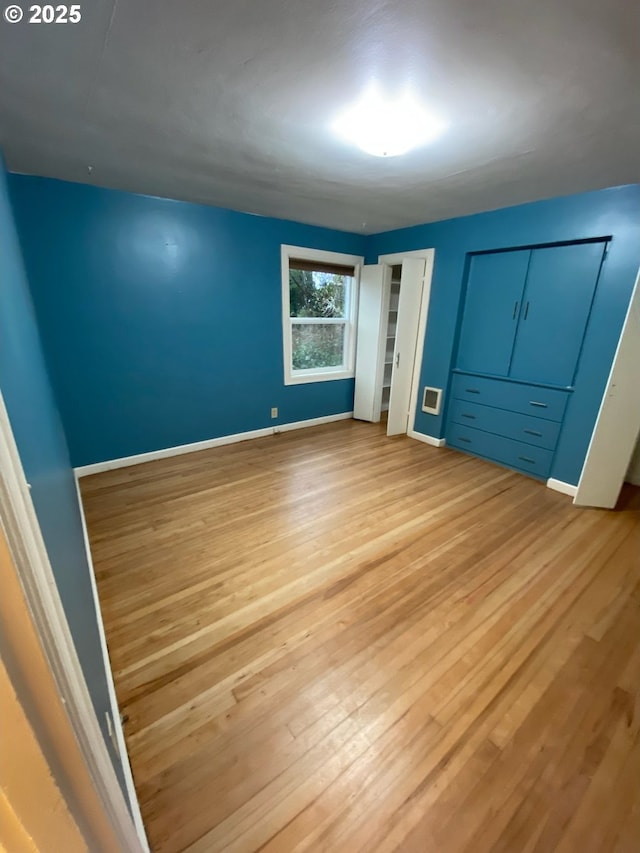 564566 Alameda Ave, Astoria, OR 97103 - unfurnished bedroom featuring light wood-type flooring and baseboards