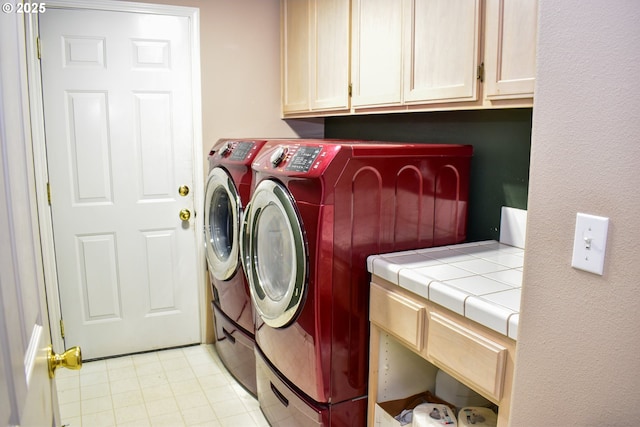 laundry area featuring independent washer and dryer and cabinets