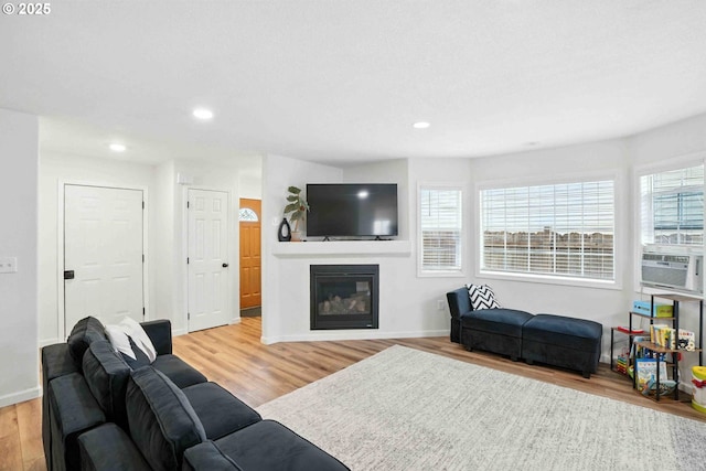 1103 W 34th Way, Vancouver, WA 98660 - living room featuring wood finished floors, a glass covered fireplace, recessed lighting, and cooling unit