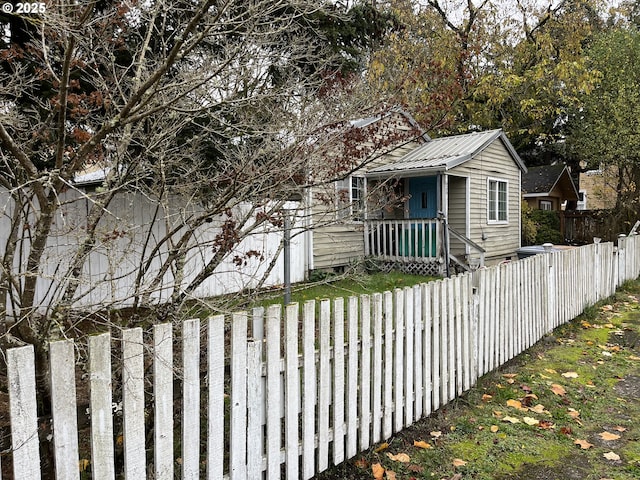 view of front of house with a fenced front yard and metal roof