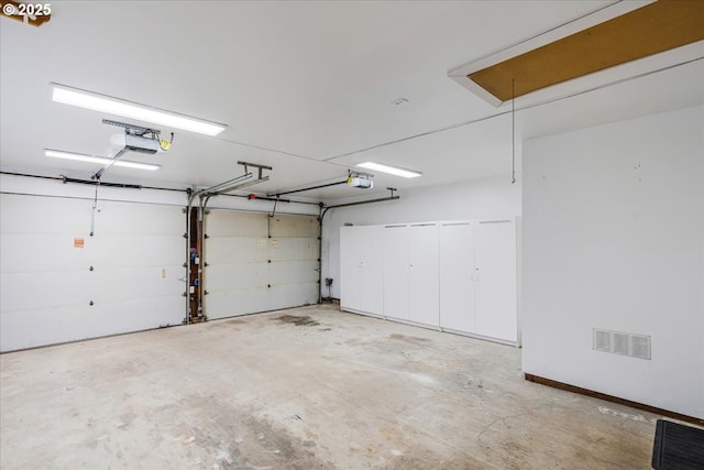 garage featuring visible vents and a garage door opener