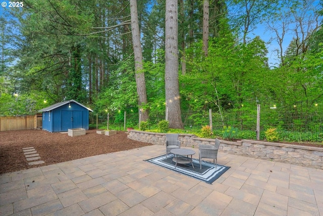 view of patio featuring a fenced backyard, an outbuilding, and a storage shed