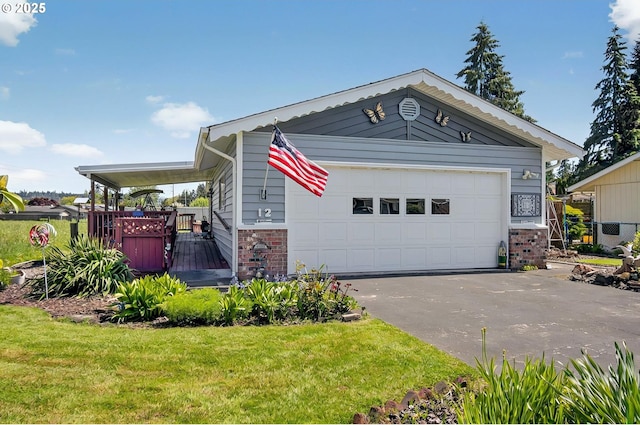 view of front facade with brick siding, a front lawn, and a garage