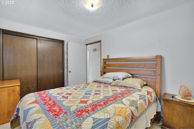 bedroom featuring carpet floors, a closet, and a textured ceiling