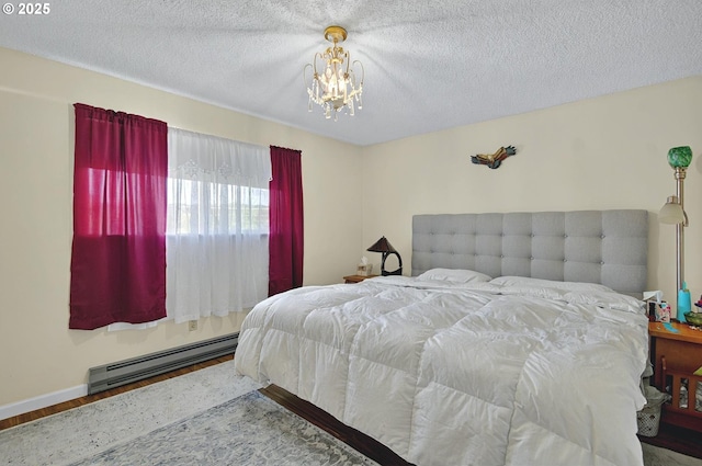 bedroom featuring a textured ceiling, an inviting chandelier, wood finished floors, and a baseboard radiator
