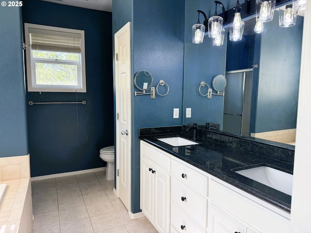 full bathroom featuring a sink, tile patterned flooring, toilet, and double vanity