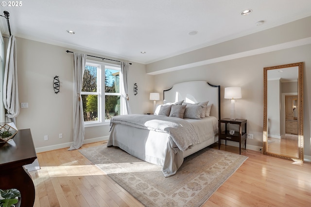 bedroom with crown molding and light hardwood / wood-style flooring