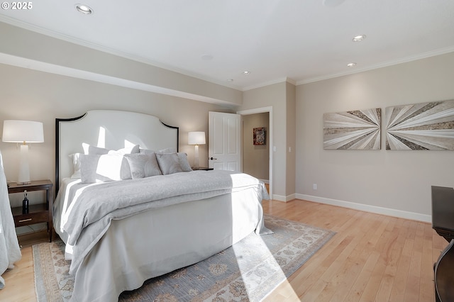 bedroom with ornamental molding and light hardwood / wood-style floors