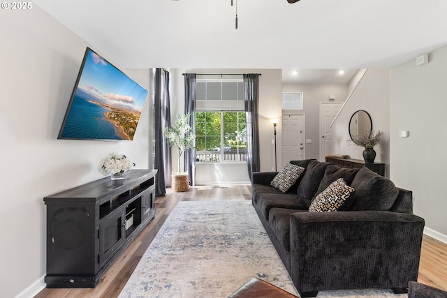 living area with wood finished floors, baseboards, and recessed lighting