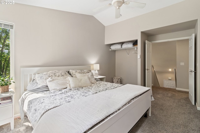 carpeted bedroom featuring lofted ceiling and a ceiling fan