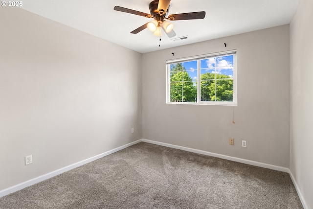 carpeted empty room featuring baseboards and a ceiling fan