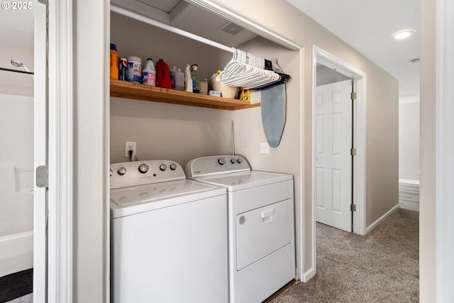 clothes washing area with washing machine and dryer and light colored carpet