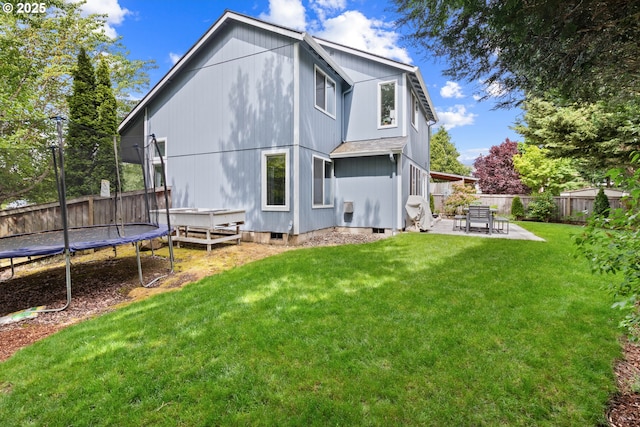 back of house featuring a patio area and a trampoline