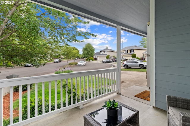 view of patio / terrace with a residential view and a porch