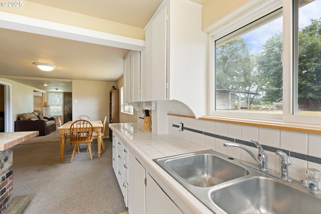 1548 Harlan St, Roseburg, OR 97471 - kitchen featuring tile countertops, white cabinetry, light colored carpet, and backsplash
