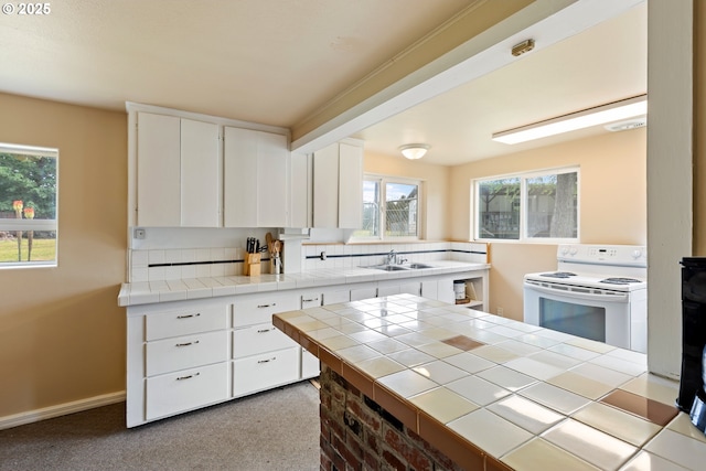 1548 Harlan St, Roseburg, OR 97471 - kitchen with white electric range oven, white cabinetry, and plenty of natural light