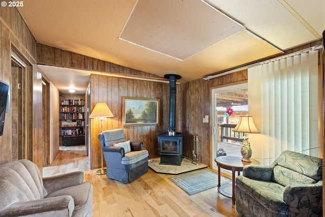 1548 Harlan St, Roseburg, OR 97471 - sitting room featuring wooden walls, a wood stove, vaulted ceiling, wood finished floors, and built in features