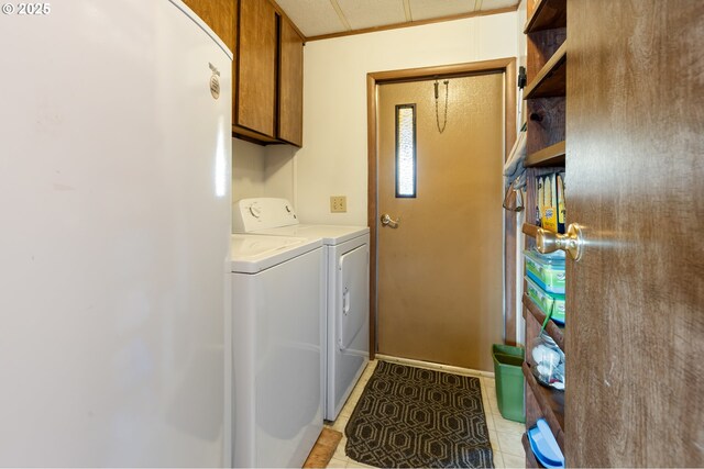 1548 Harlan St, Roseburg, OR 97471 - laundry area featuring cabinet space, washer and clothes dryer, and light tile patterned flooring