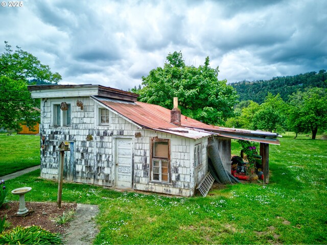 1548 Harlan St, Roseburg, OR 97471 - back of house featuring a yard and a metal roof