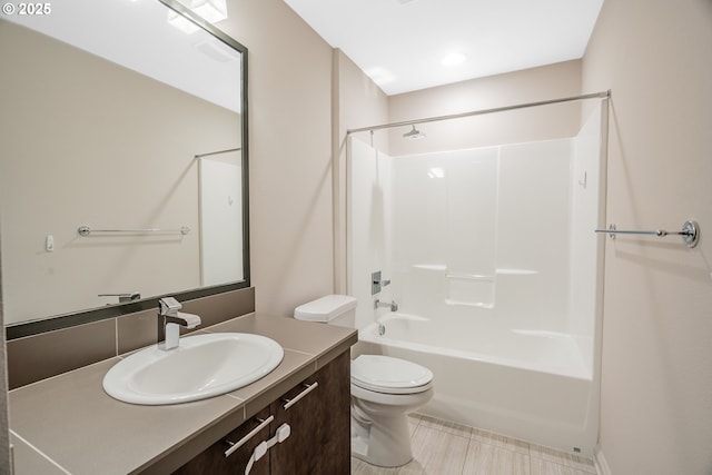 bathroom featuring vanity, bathing tub / shower combination, and toilet