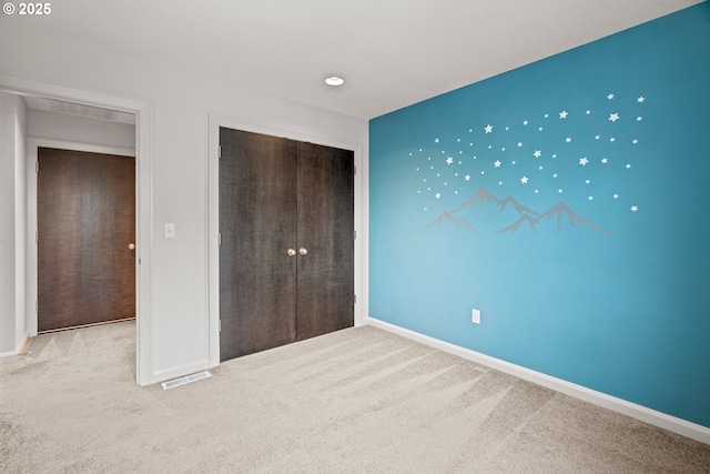 unfurnished bedroom featuring visible vents, baseboards, and carpet floors