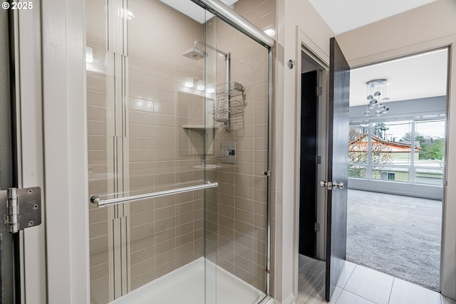 bathroom featuring tile patterned flooring and a stall shower