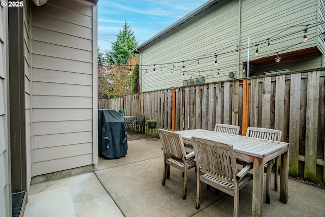 view of patio / terrace with outdoor dining space, area for grilling, and fence