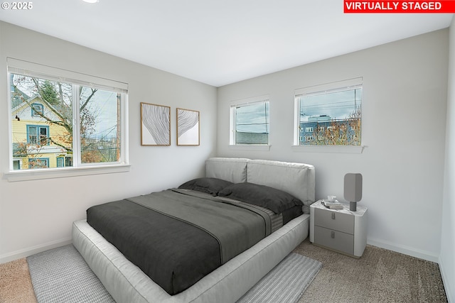 bedroom featuring carpet flooring and baseboards