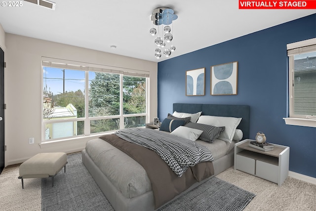 carpeted bedroom with visible vents and baseboards