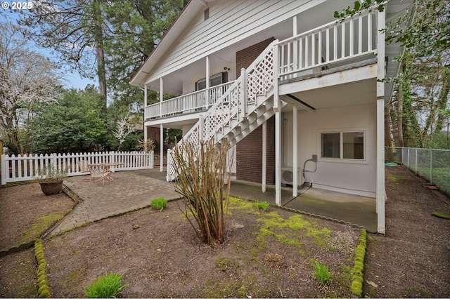 back of property featuring a patio area, stairway, ac unit, and fence