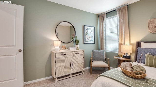 bedroom featuring baseboards, multiple windows, and light carpet